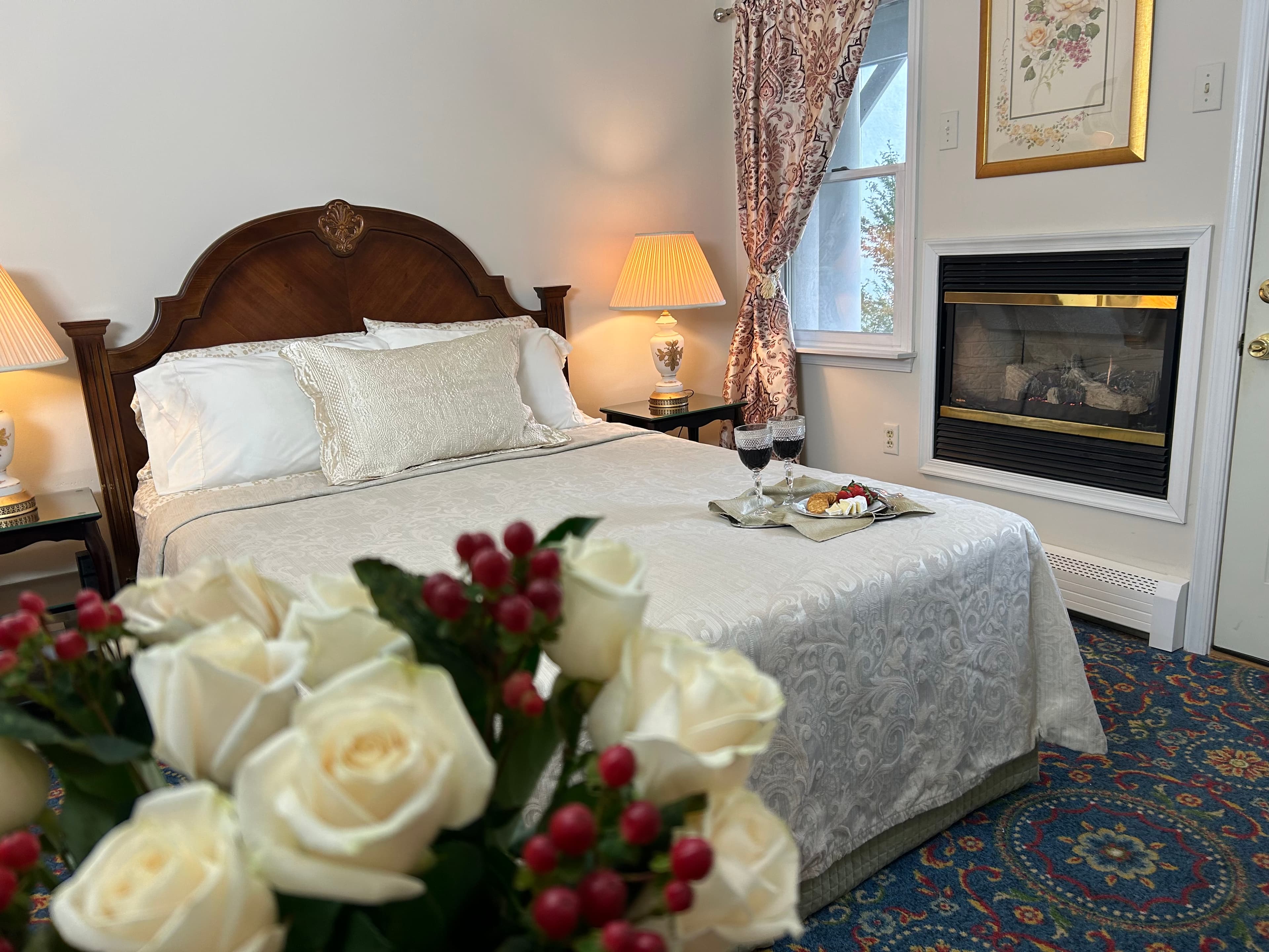 "Front view of queen sized bed with flowers in foreground