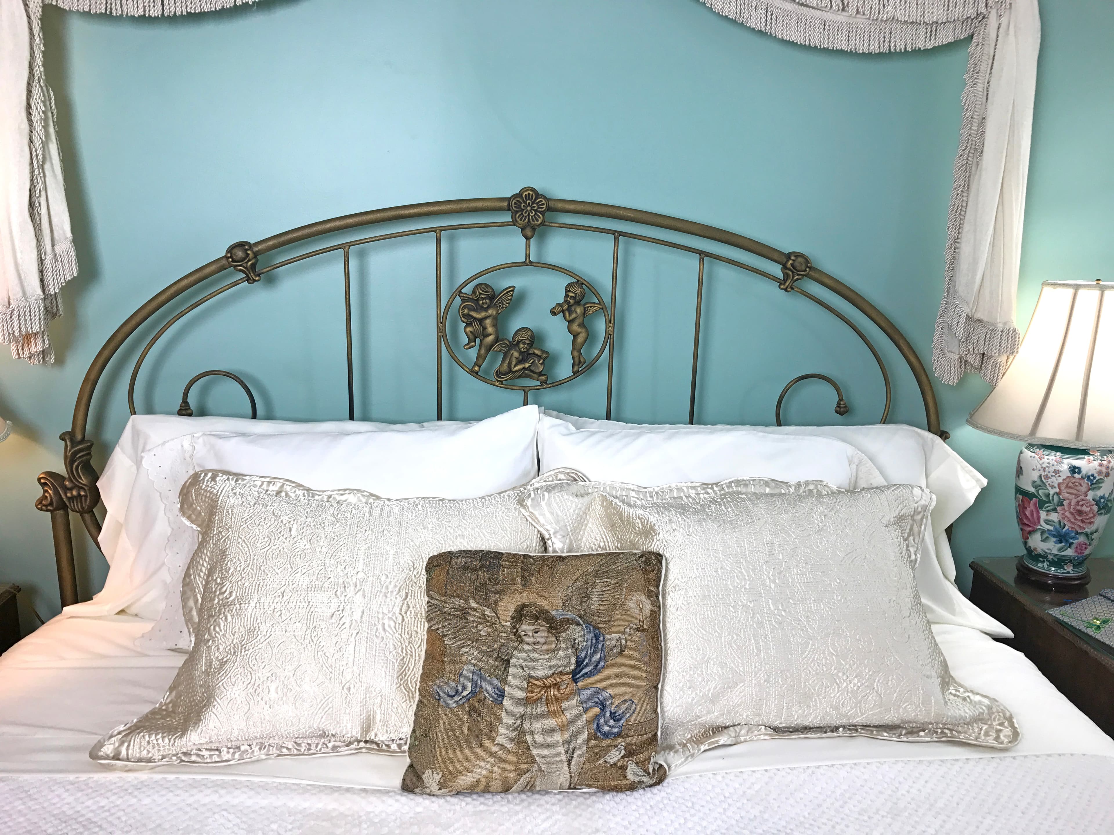 "close up of headboard with cherubs"