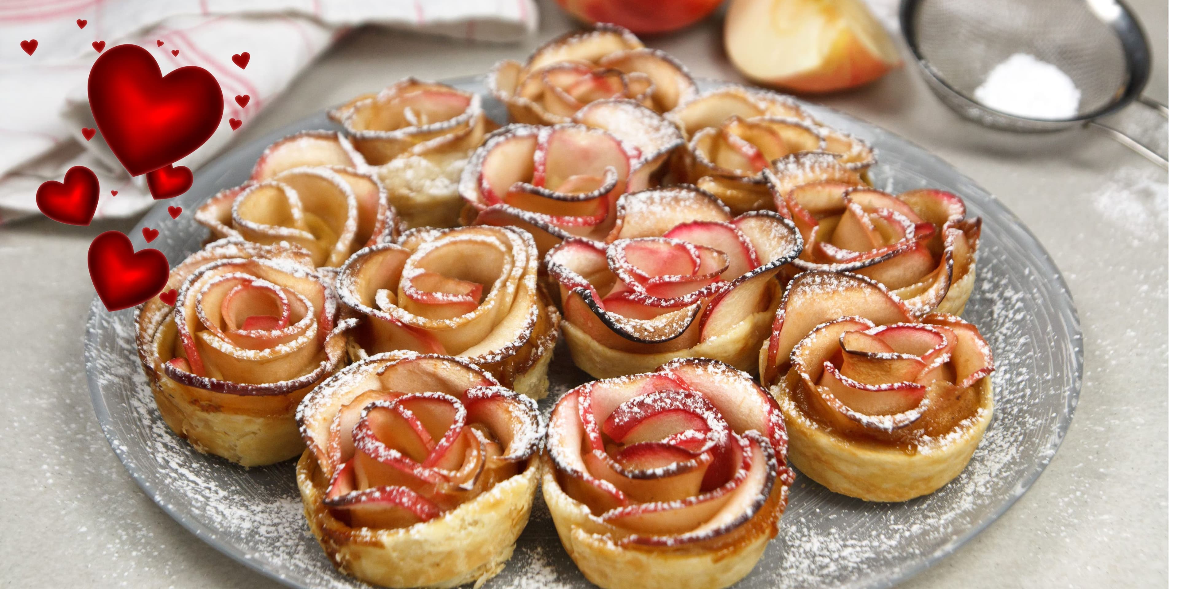 A platter of apple rose pastries dusted with powdered sugar. A platter of apple rose pastries dusted with powdered sugar.